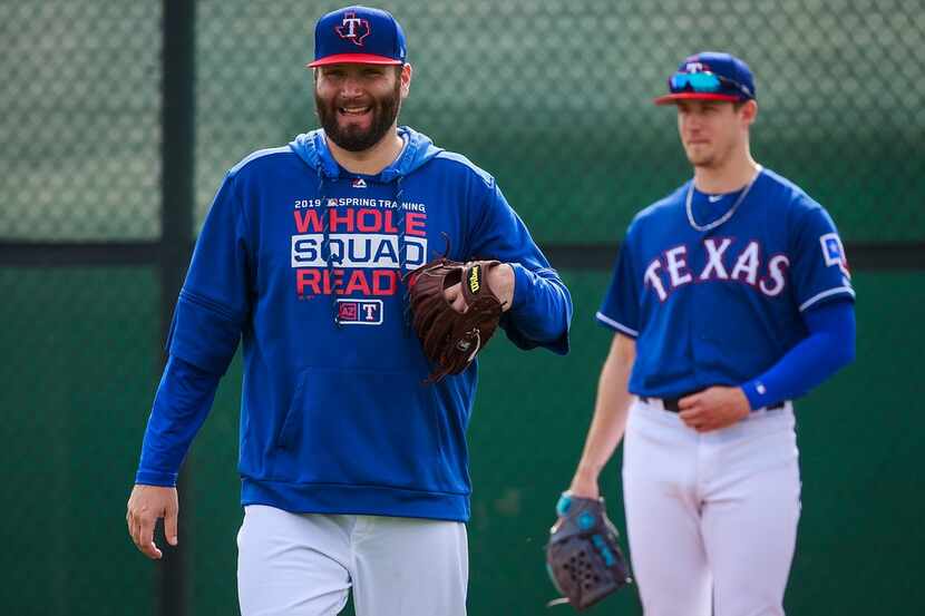 Texas Rangers pitcher Lance Lynn (left) laughts with teammates during a spring training...