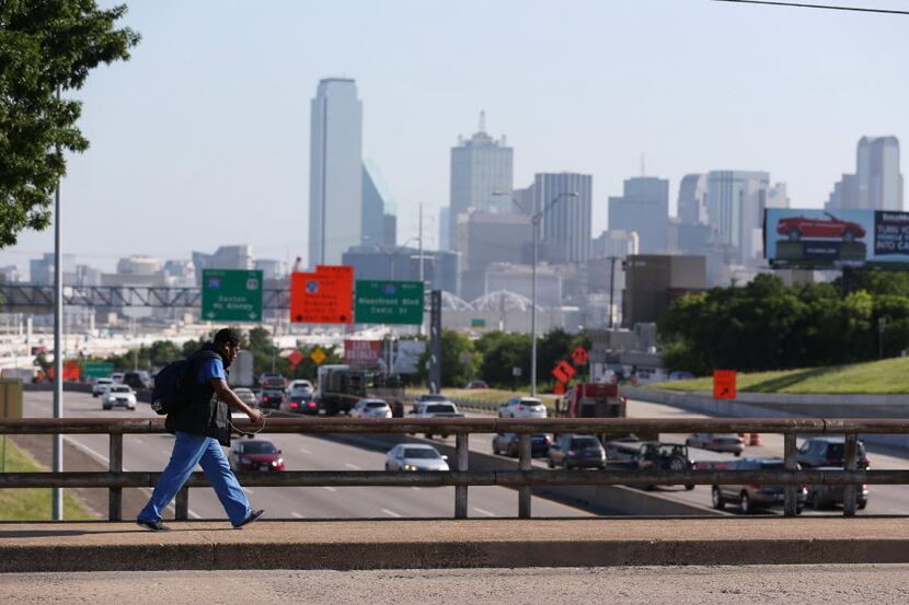 A pedestrian crosses over Interstate 35 along E. 8th Street in Dallas Tuesday June 22, 2016. 