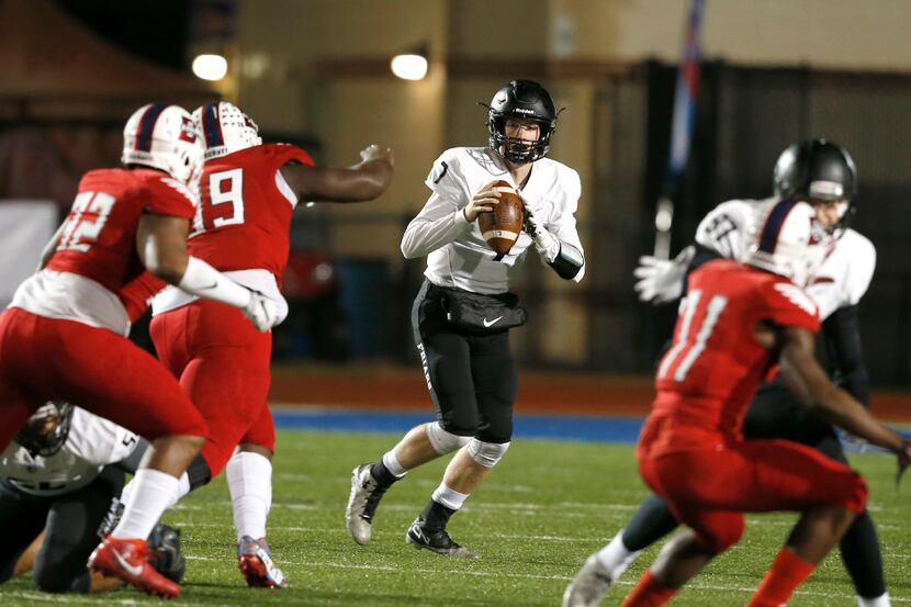 
Bishop Lynch High School Friars Jagger LaRoe looks for receivers during the first half of a...