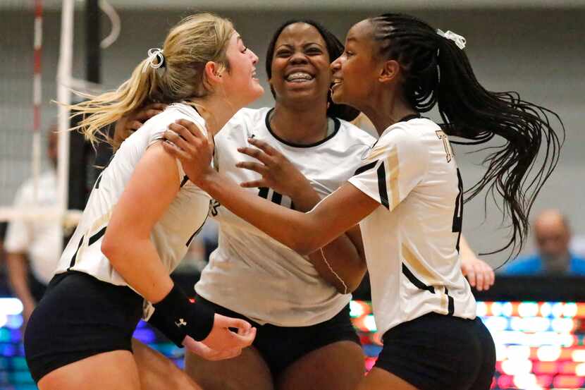 Mansfield's Ava Roberts (14), Tyla Perry (18) and Brynn Williams (4) celebrate a point...