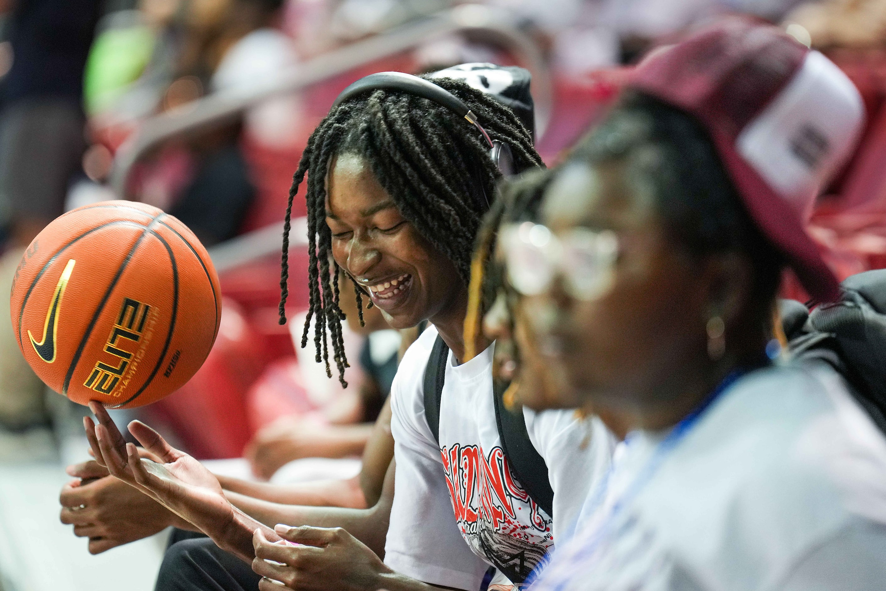 Jacoi Jones spins a basketball while watching the 8th Annual Together We Ball basketball...