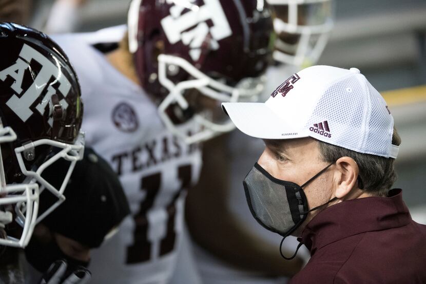 Texas A&M head coach Jimbo Fisher prepares to take the field with players before an NCAA...