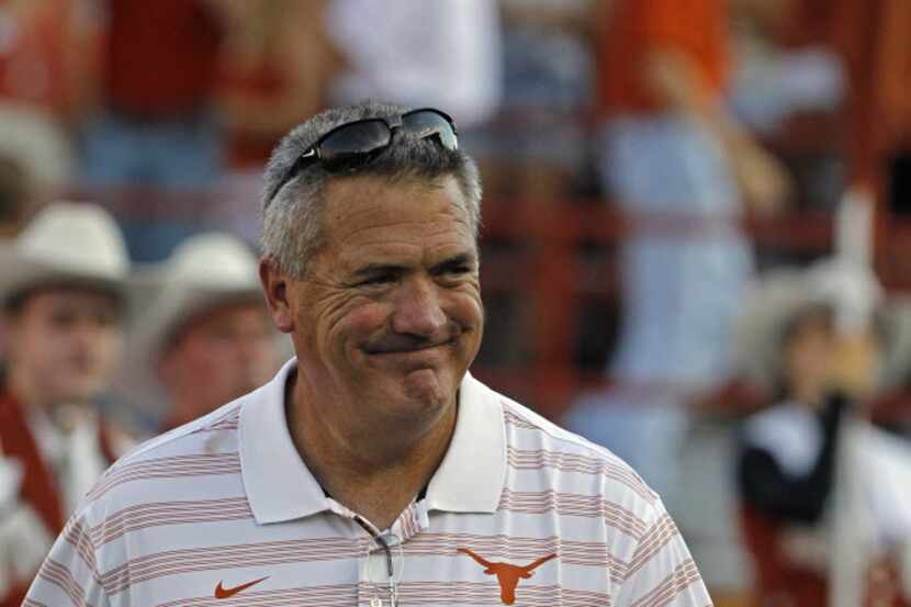 Texas offensive line coach Joe Wickline comes onto the field before a game between Texas and...