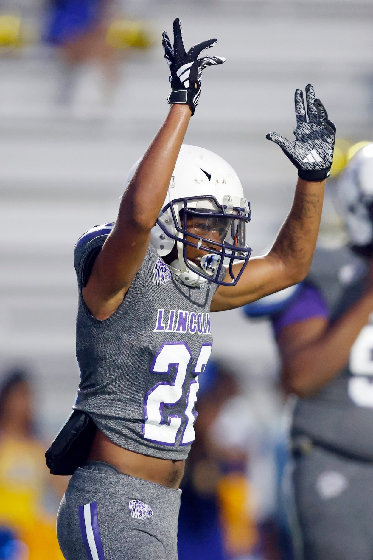 Lincoln running back Demarcus Sypho (22) raises his arms in celebration after scoring a...