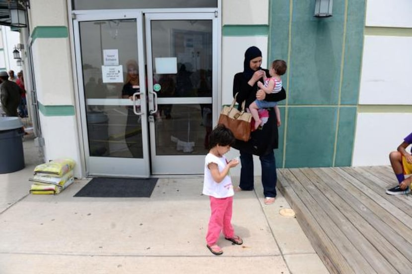 
Randa Ahmed and her daughters, Danah, 3, and Zainah, members of the East Plano Islamic...