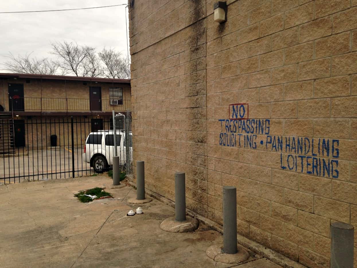 The signage on the liquor store that backs up to the complex at 3006 Holmes Street in South...