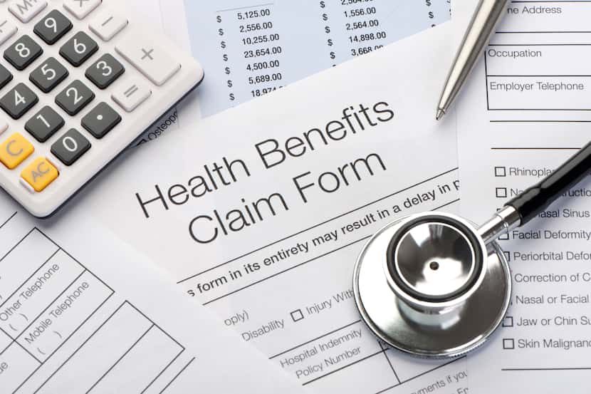 Close up a Health benefits claim form with calculator, pen and stethoscope
