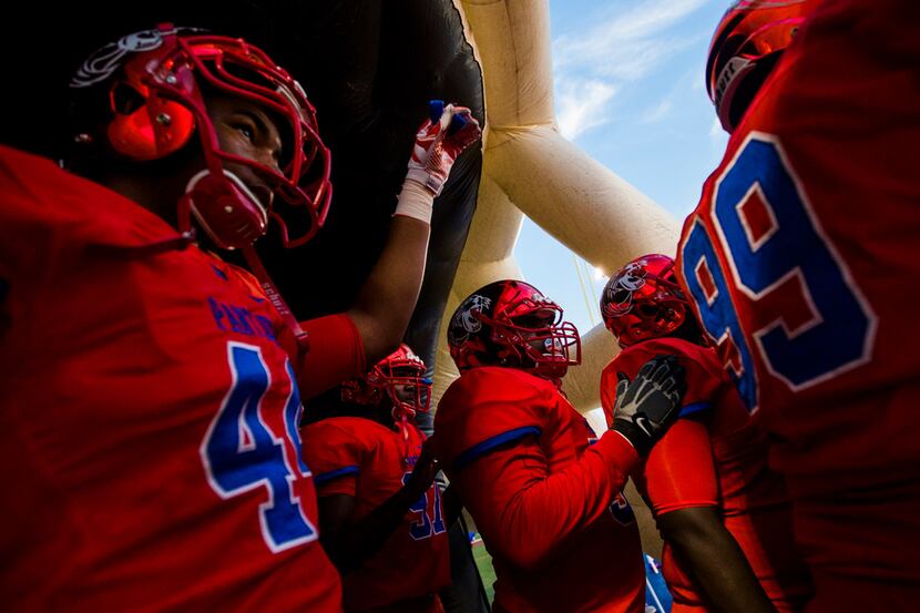 Duncanville players prepare to enter the field before a high school football game between...