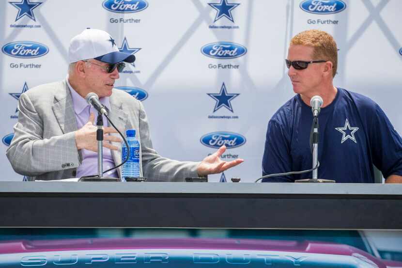 Dallas Cowboys owner Jerry Jones gestures to head coach Jason Garrett during the Cowboys...