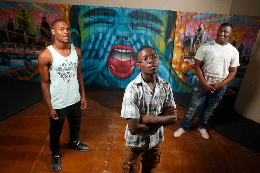Vertiz Wood, 19, (from left) Colby Glaspie, 16, and Dejahn Carr, 18, read their poetry for a...