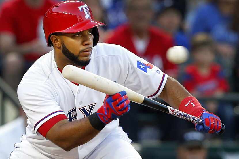 Texas Rangers shortstop Elvis Andrus (1) squares to bunt as Rougned Odor steals second...