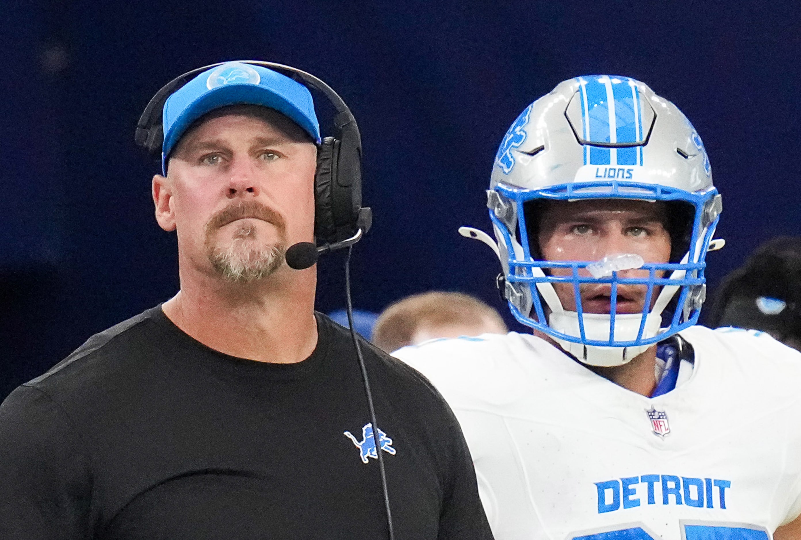 Detroit Lions head coach Dan Campbell looks on from the sidelines with tight end Sam LaPorta...