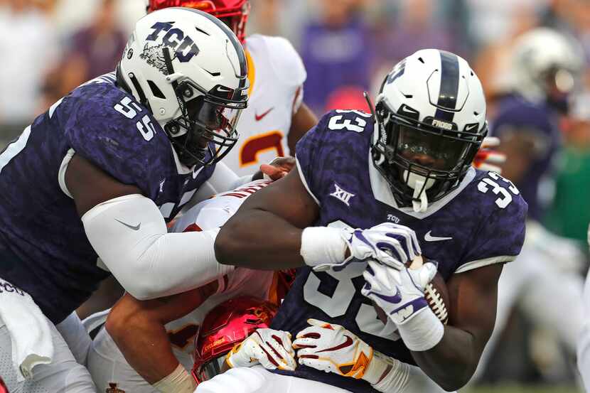 TCU running back Sewo Olonilua (33) is brought down after a short gain in the first half of...