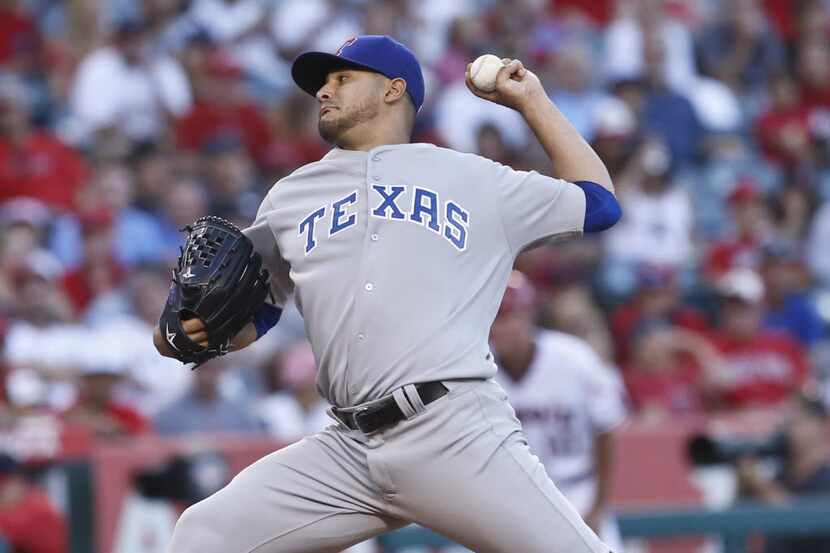 Texas Rangers starting pitcher Martin Perez works against the Los Angeles Angels in the...