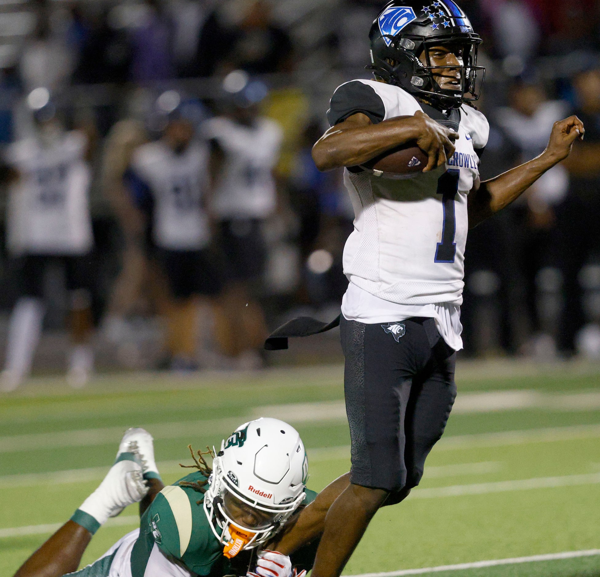 North Crowley's Cornelius Warren (1) is tackled by DeSoto's Sael Reyes (2) during the second...