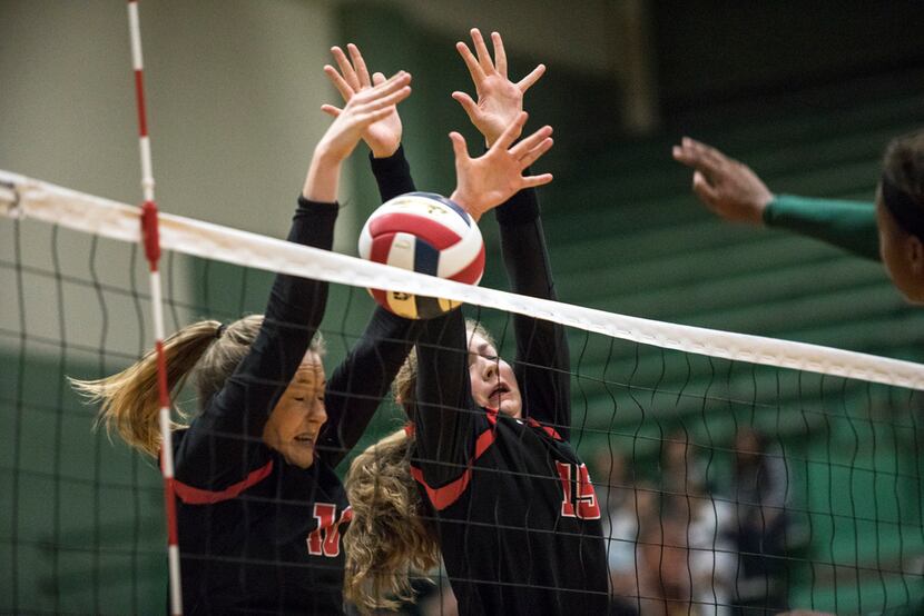 Lovejoy outside hitter Madison Waters (10) and middle blocker Rachel Langs (15) block a...