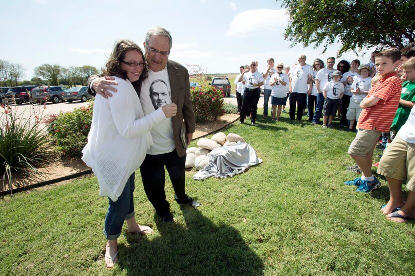 
Pastor Fred Campbell (right) hugs member Catherine Homburg outside Grace Church of Ovilla....