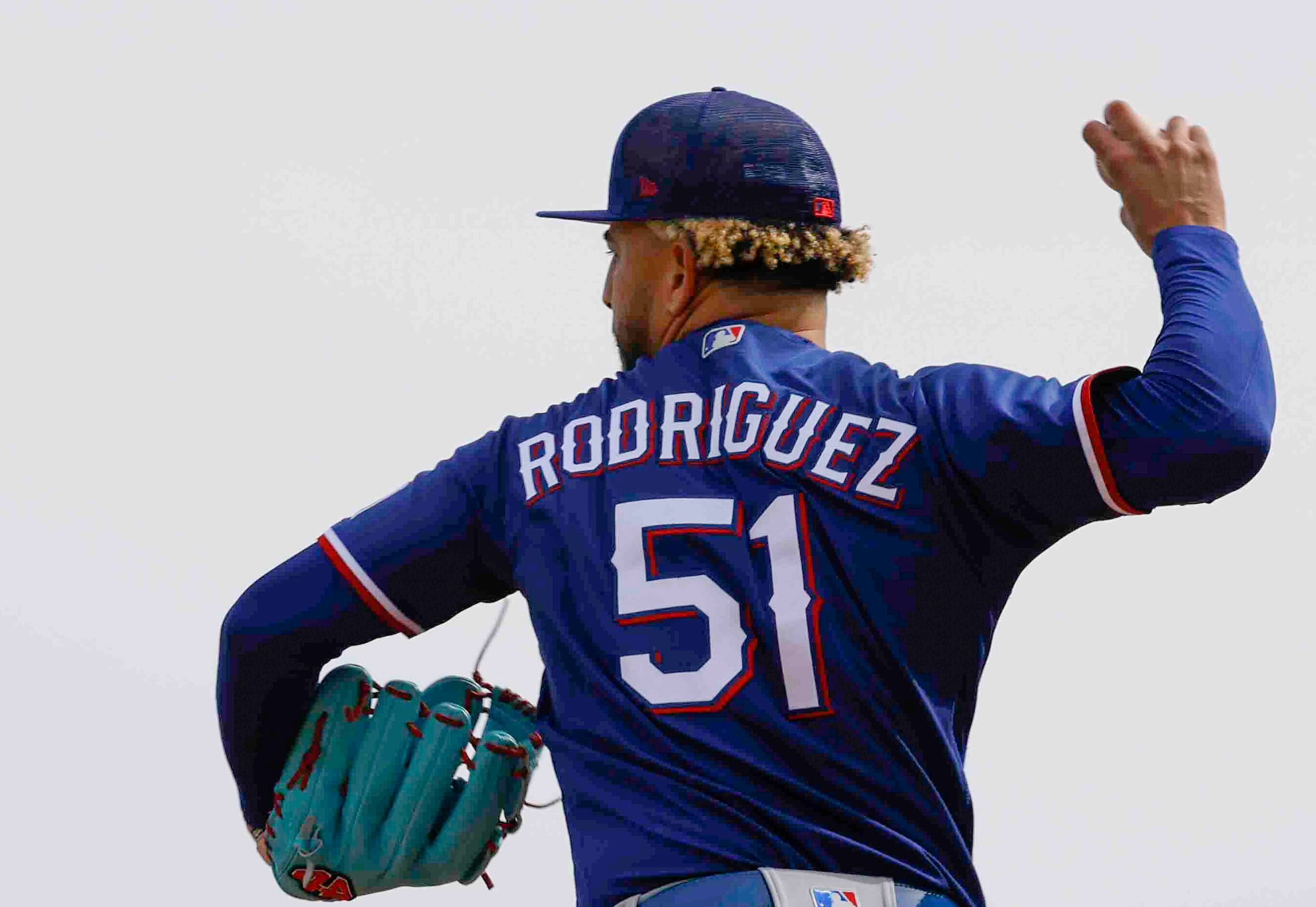 Texas Rangers pitcher Yerry Rodriguez throws a pitch during a spring training workout at the...