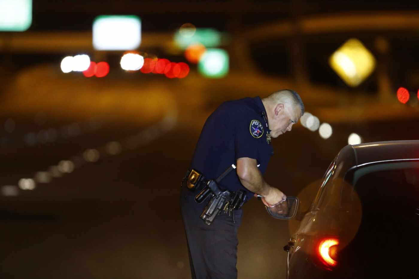 Officer Stephen Burres III talks to a driver in Irving on July 21.