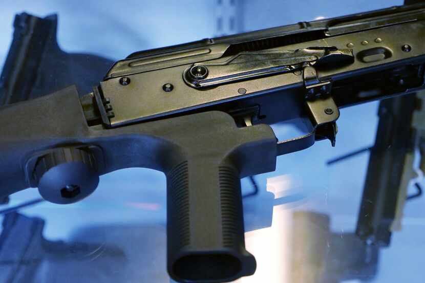 FILE - A bump stock is attached to a semi-automatic rifle at The Gun Vault in South Jordan,...