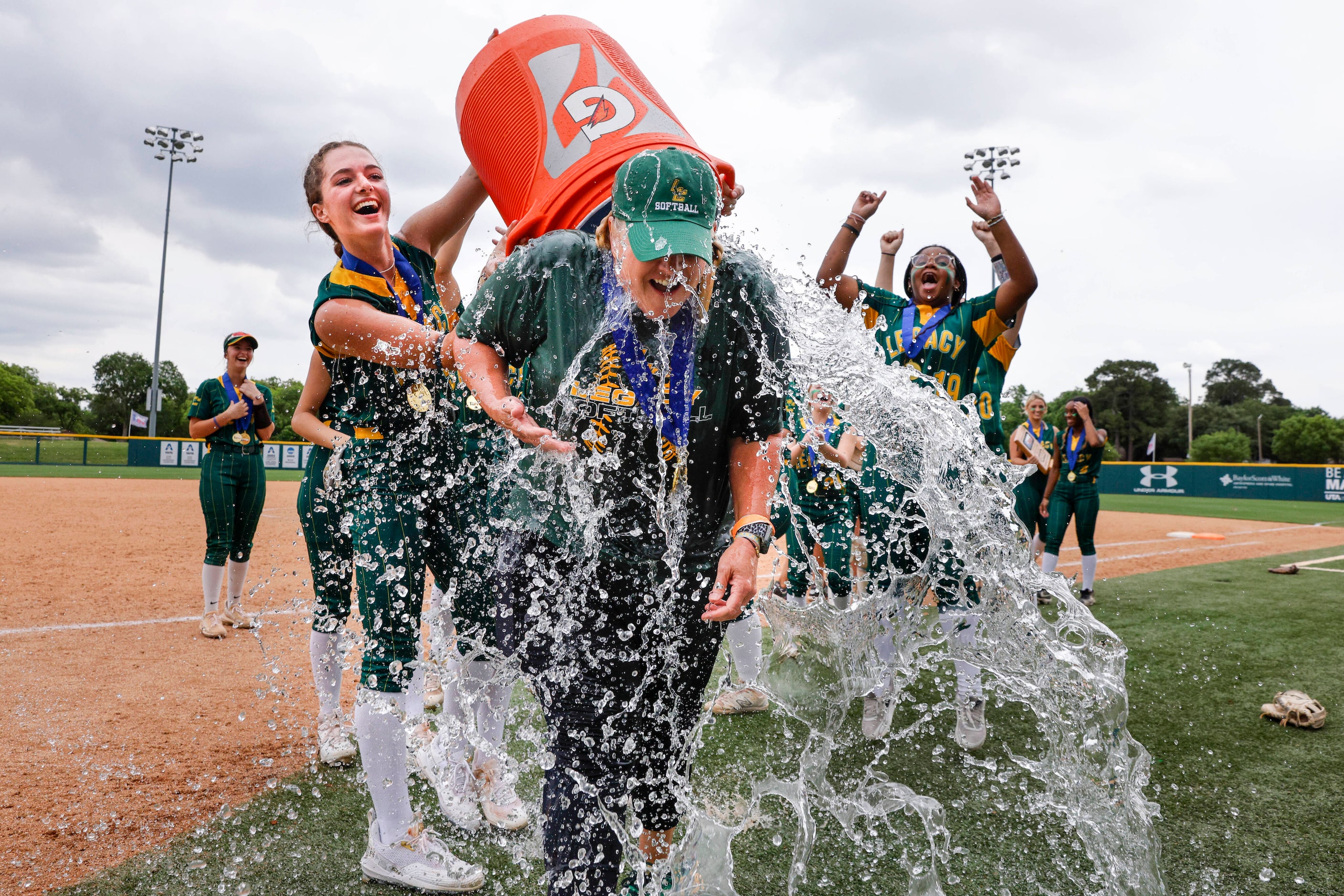 Frisco Legacy Christian outfielder Alexandra Thomas (5) douses head coach Amy Coe with water...