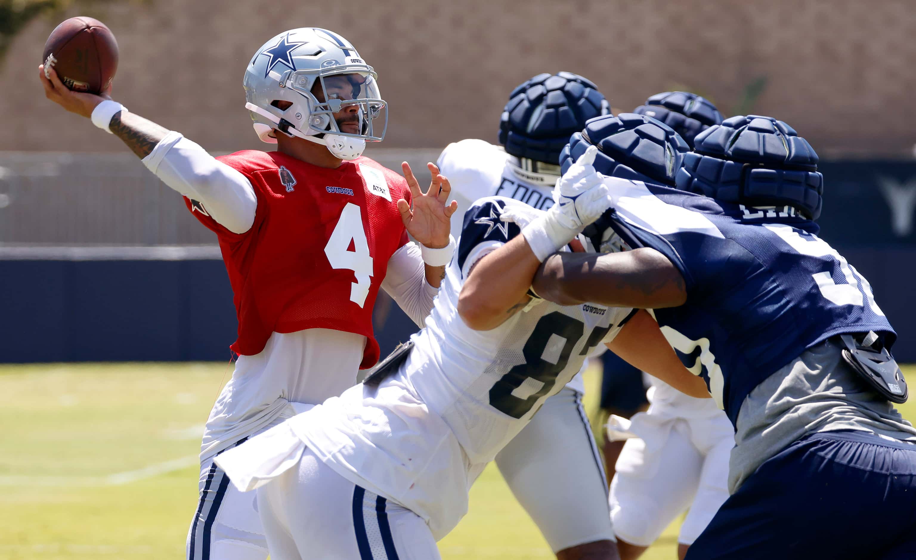 Dallas Cowboys quarterback Dak Prescott (4) fires a pass downfield as he receives blocking...