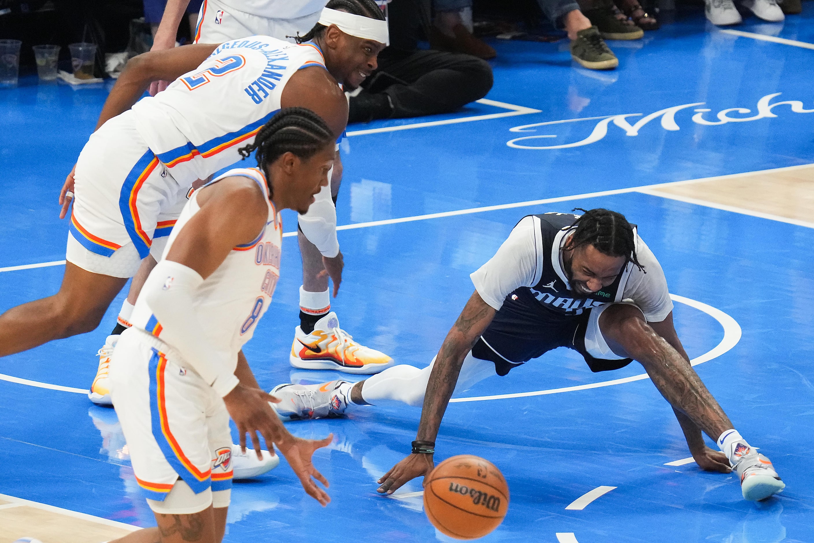 Oklahoma City Thunder forward Jalen Williams (8) scoops up the ball as guard Shai...