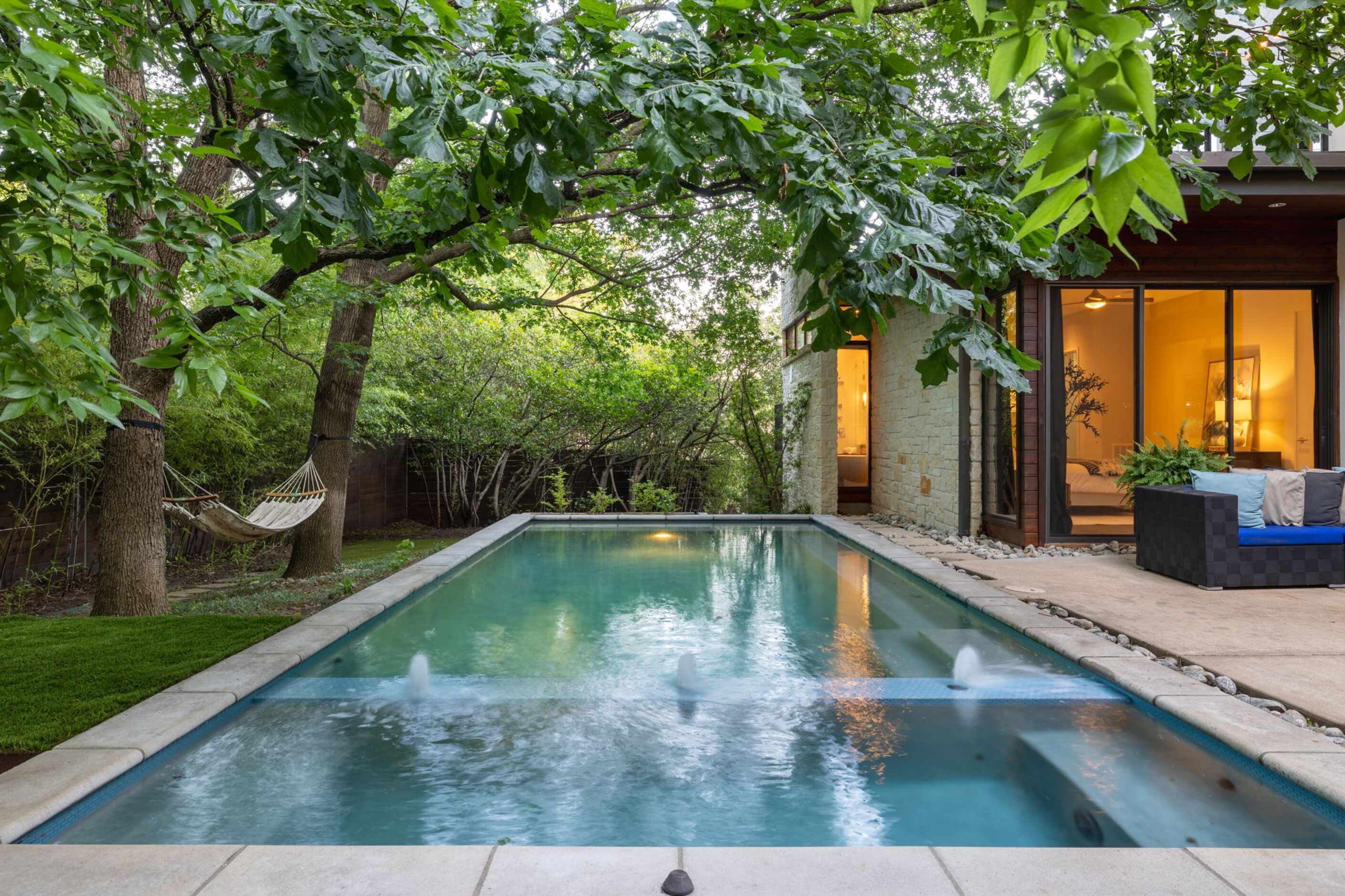 Large pool near back patio of contemporary home