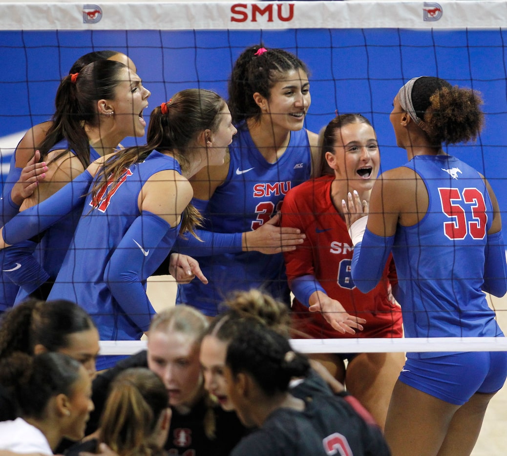 SMU outside hitter Natalie Perdue (53) right, receives a lot of praise from teammates after...