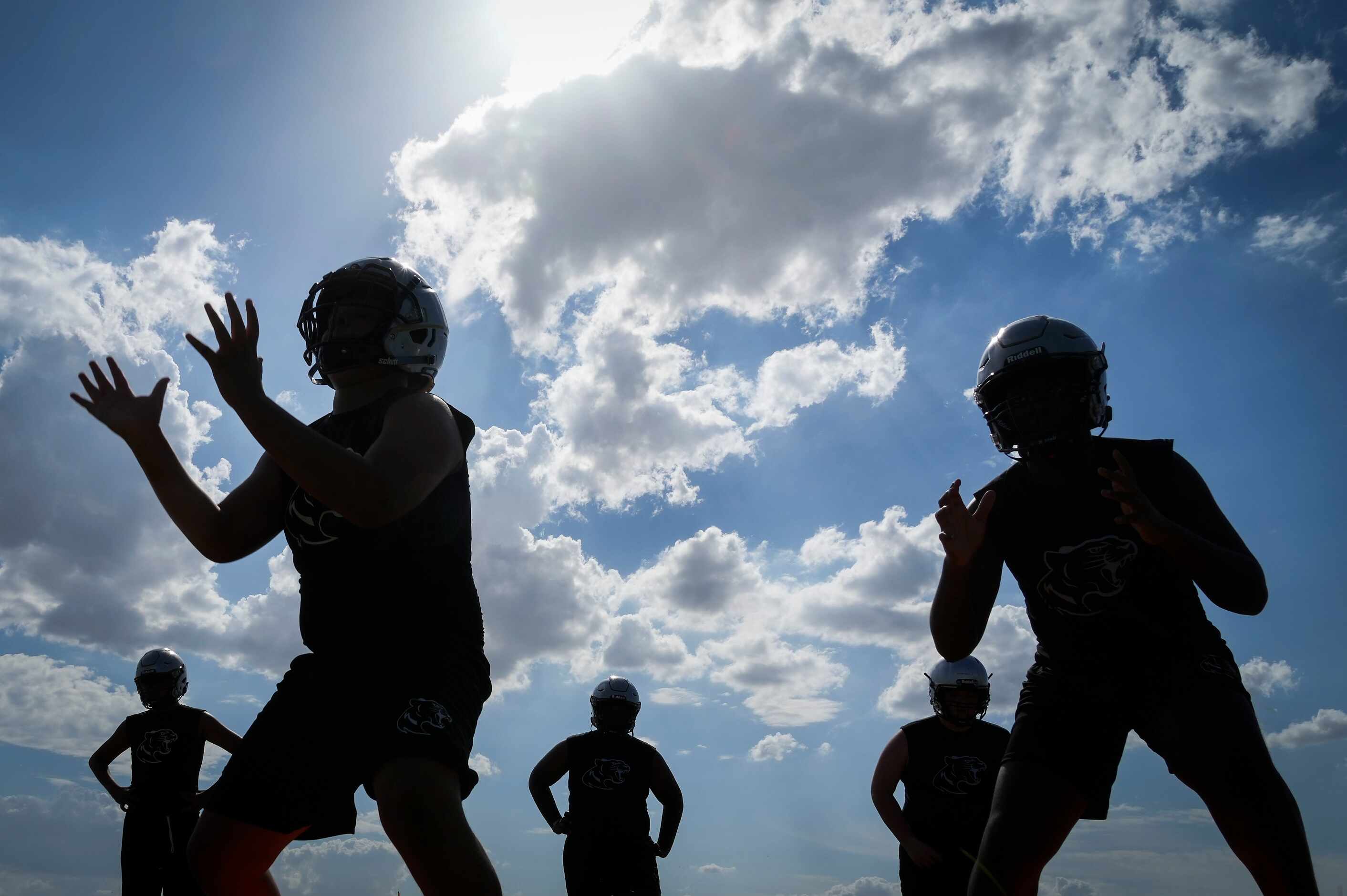 Players run drills during the first day of football practice for Frisco Panther Creek High...