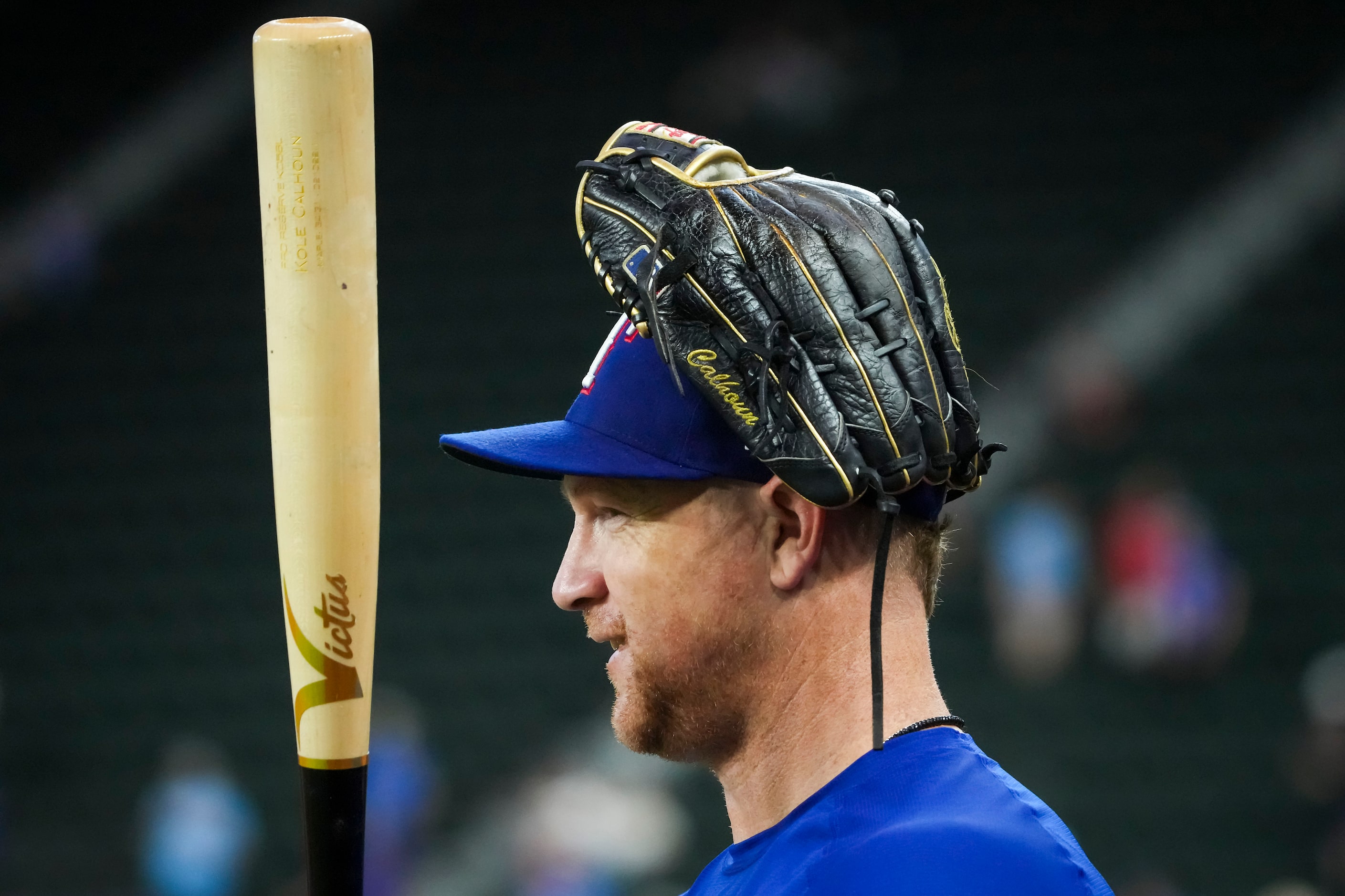 Texas Rangers right fielder Kole Calhoun looks out on the field during batting practice...