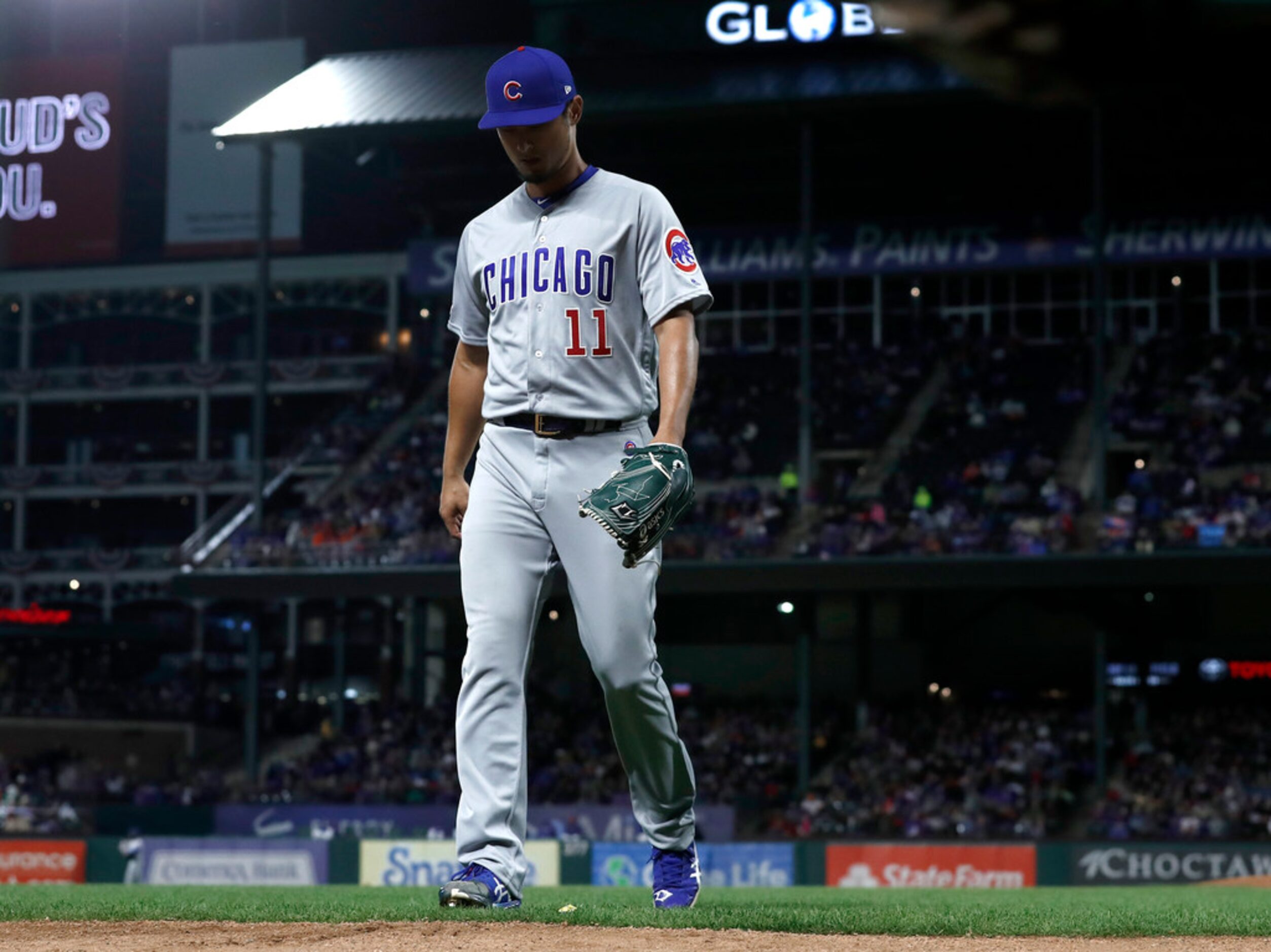 Chicago Cubs starting pitcher Yu Darvish (11) walks to the dugout after being pulled in the...