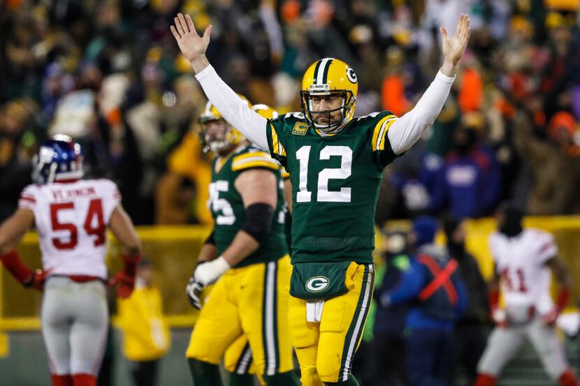 Green Bay Packers Aaron Rodgers reacts after his touchdown pass to Randall Cobb during an...
