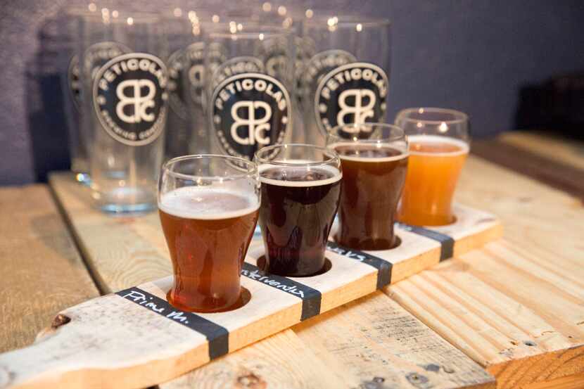 A flight of Peticolas Brewing Company beers including Prime Minister, Wintervention, Itâs...