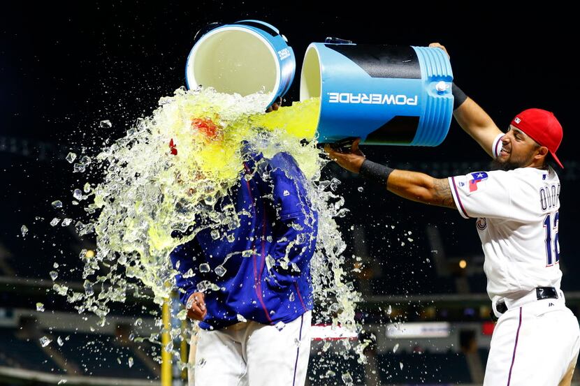 Texas Rangers starting pitcher A.J. Griffin (64) receives the post game shower by Rougned...