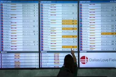 Flight status boards show Southwest flights either cancelled or delayed up and down the...