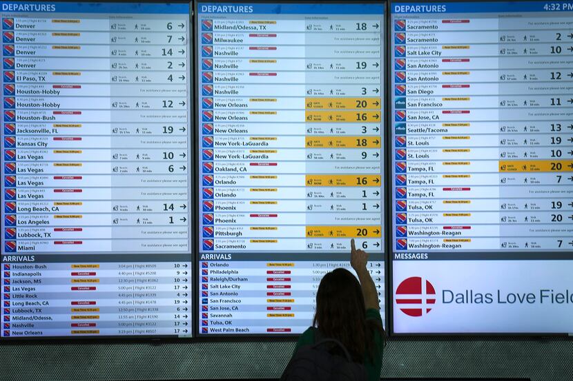 Flight status boards show Southwest flights either canceled or delayed up and down the board...