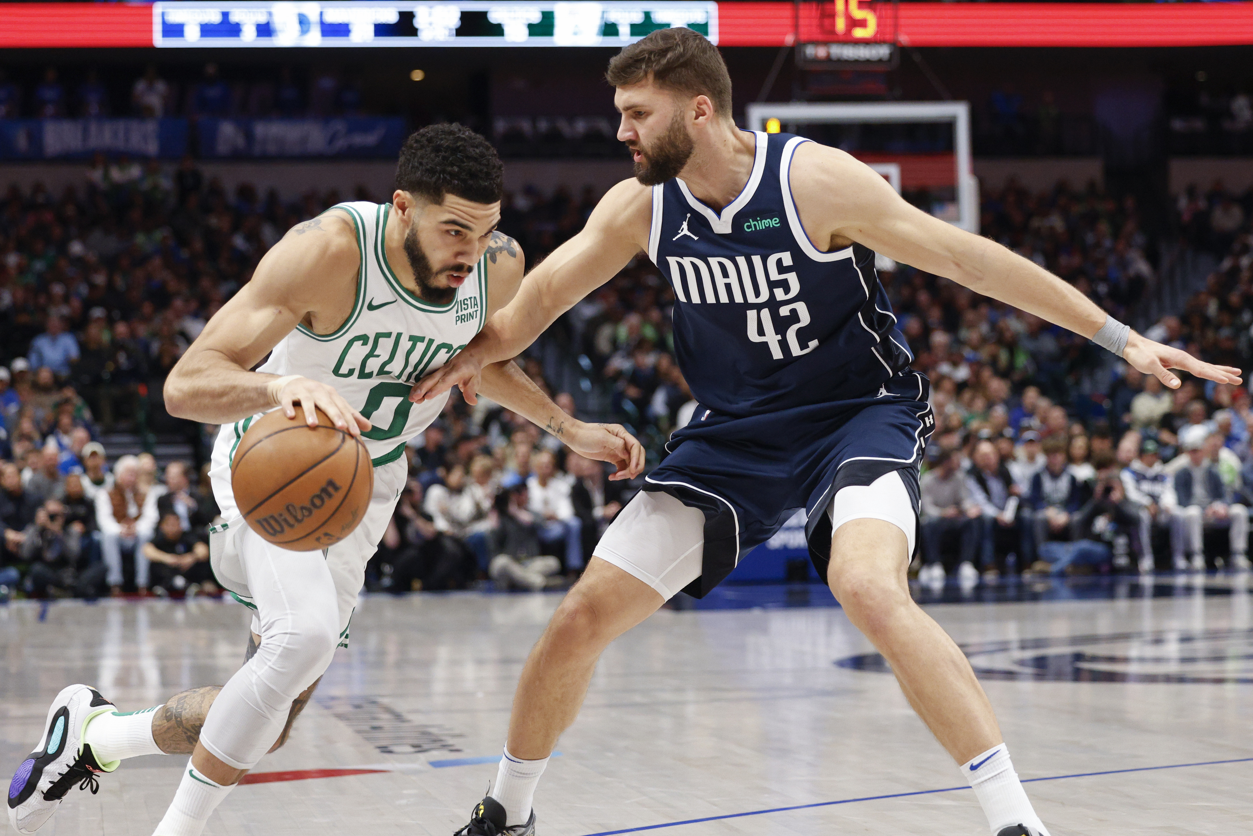 Boston Celtics forward Jayson Tatum (0) drives the ball against Dallas Mavericks forward...