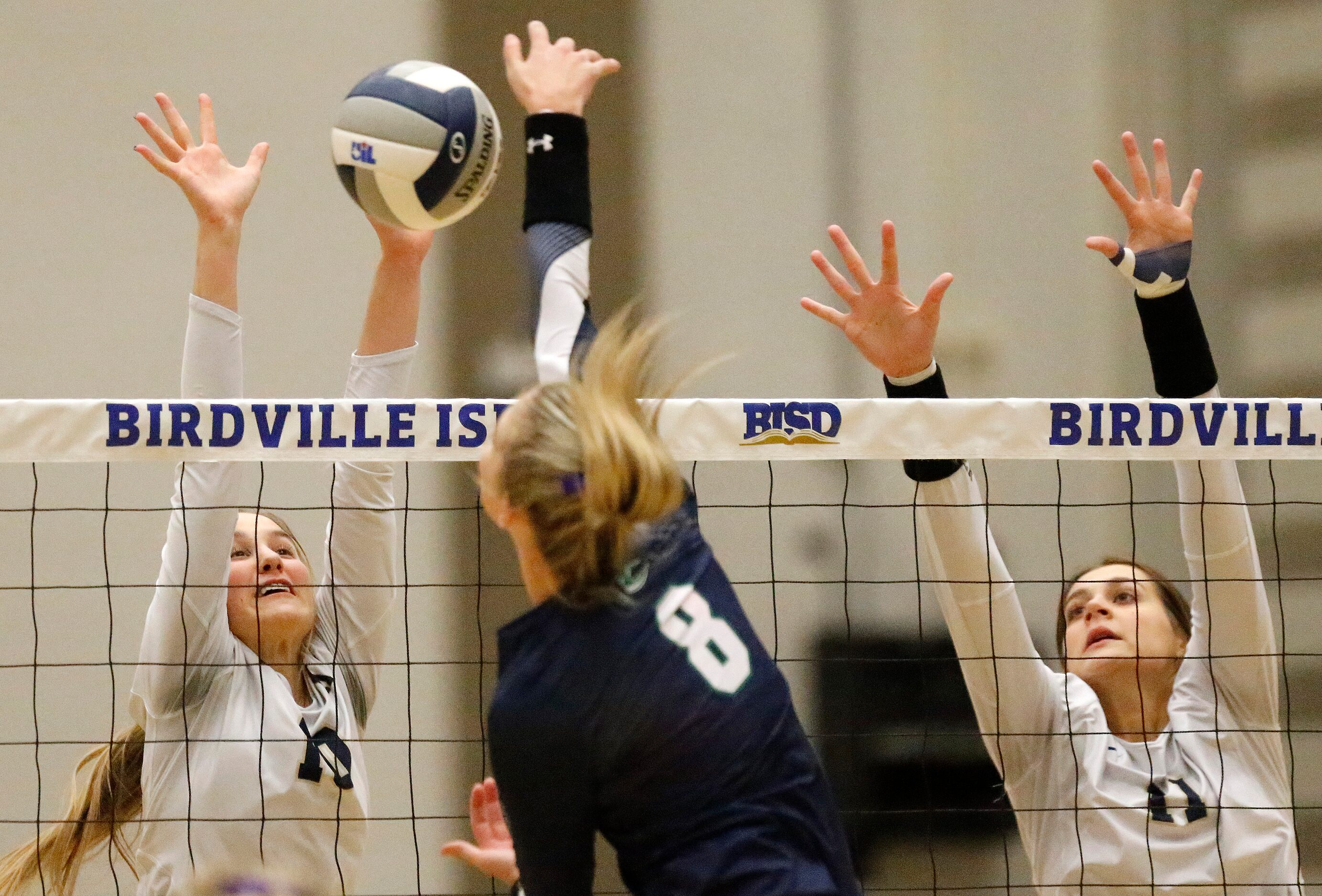 V.R. Eaton High School middle blocker Lindsey Harris (8) hits the ball as Keller High School...