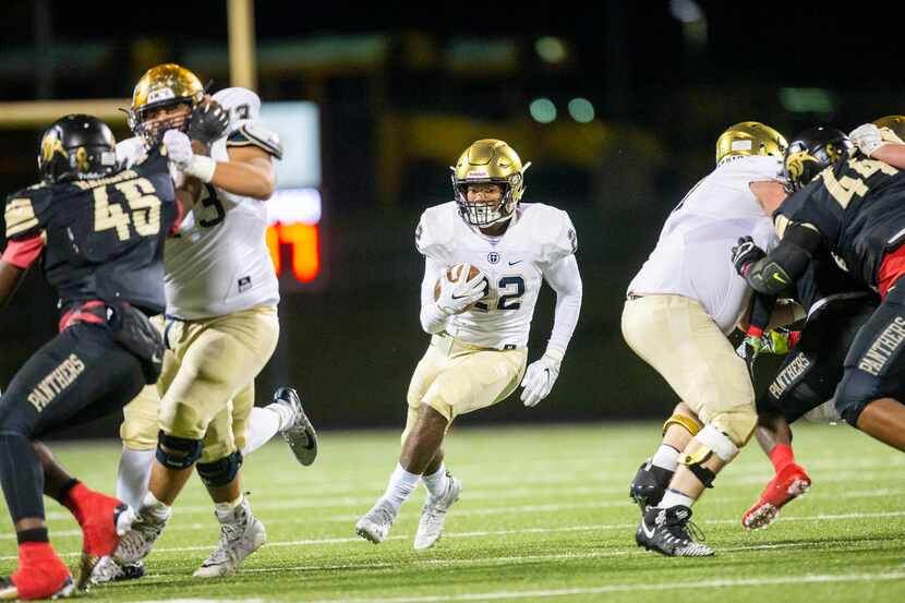 Jesuit running back E.J. Smith (22) carries the ball during the first half of a Jesuit...