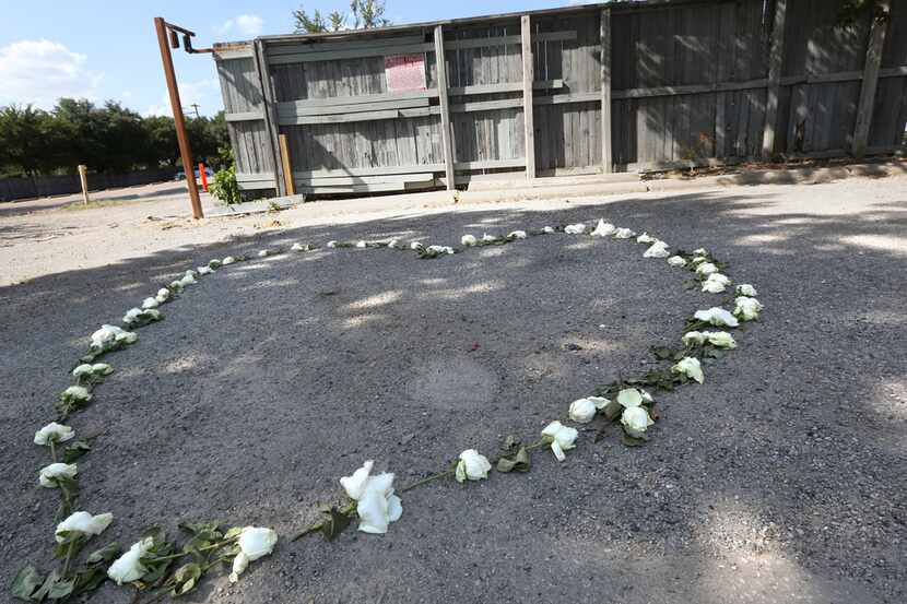 A memorial for Sara Hudson made from roses in the shape of hearts lies a few blocks west of...