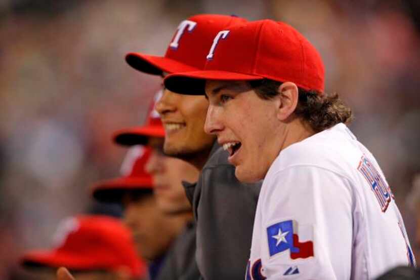 
Texas Rangers starting pitcher Derek Holland (45) watches the the ninth inning from the...