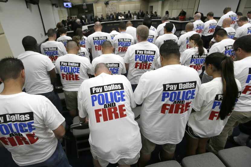 Dallas police and firefighters fill the gallery for a city council budget meeting at Dallas...