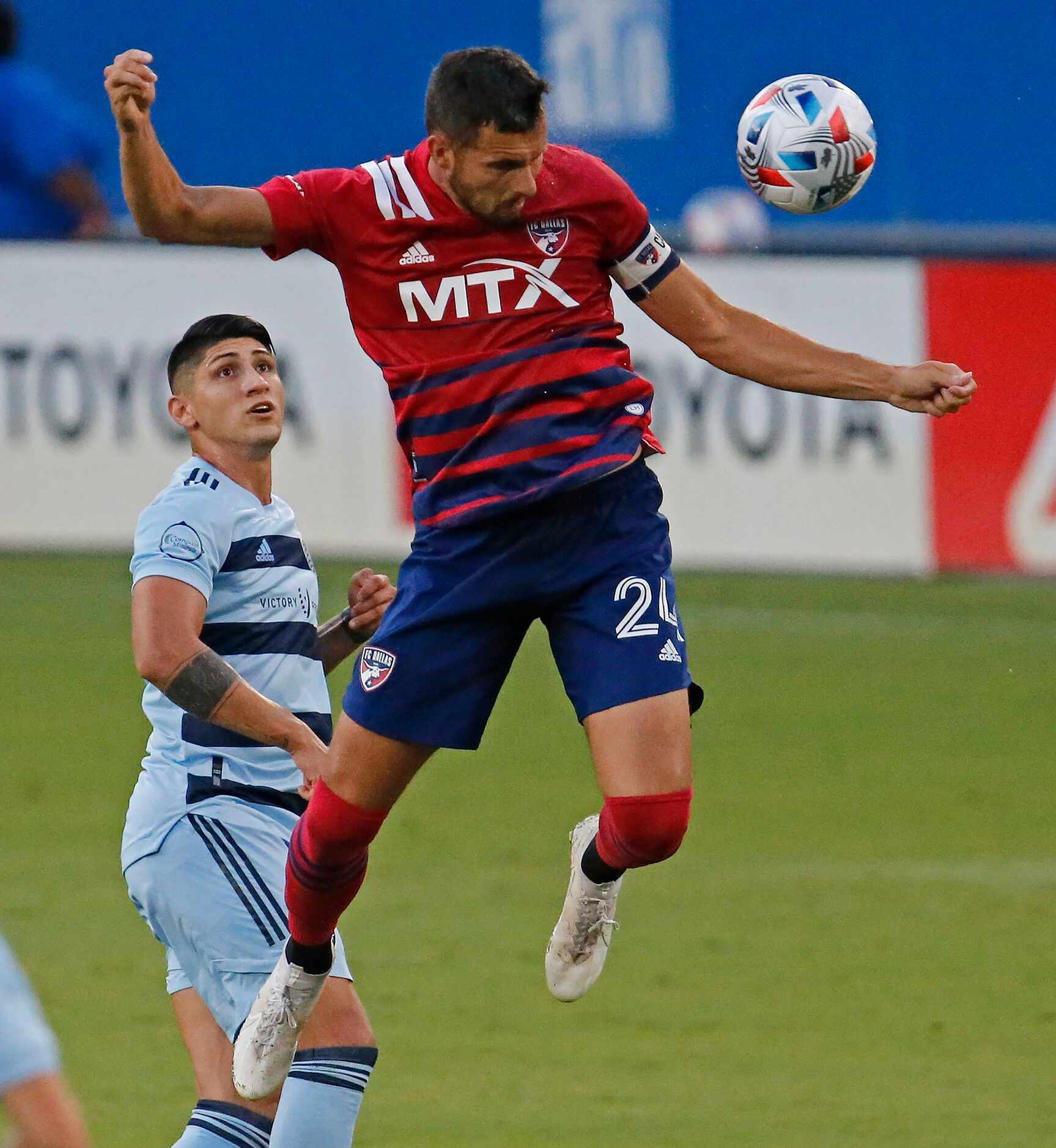 FC Dallas defender Matt Hedges (24) heads the soccer ball during the first half as FC Dallas...