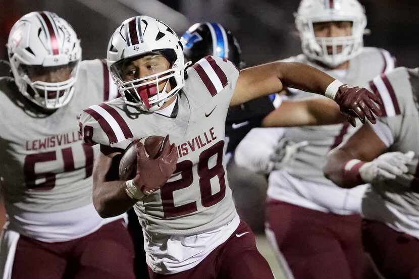 Lewisville High School running back Tenel Hill (28) carries the football during the second...