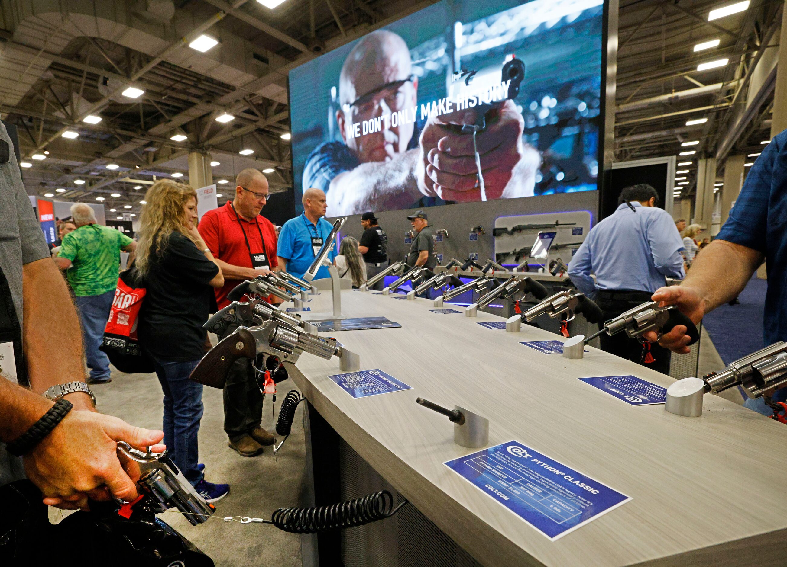 People check the products at the booth of Colt during 2024 NRA Annual Meetings & Exhibits at...