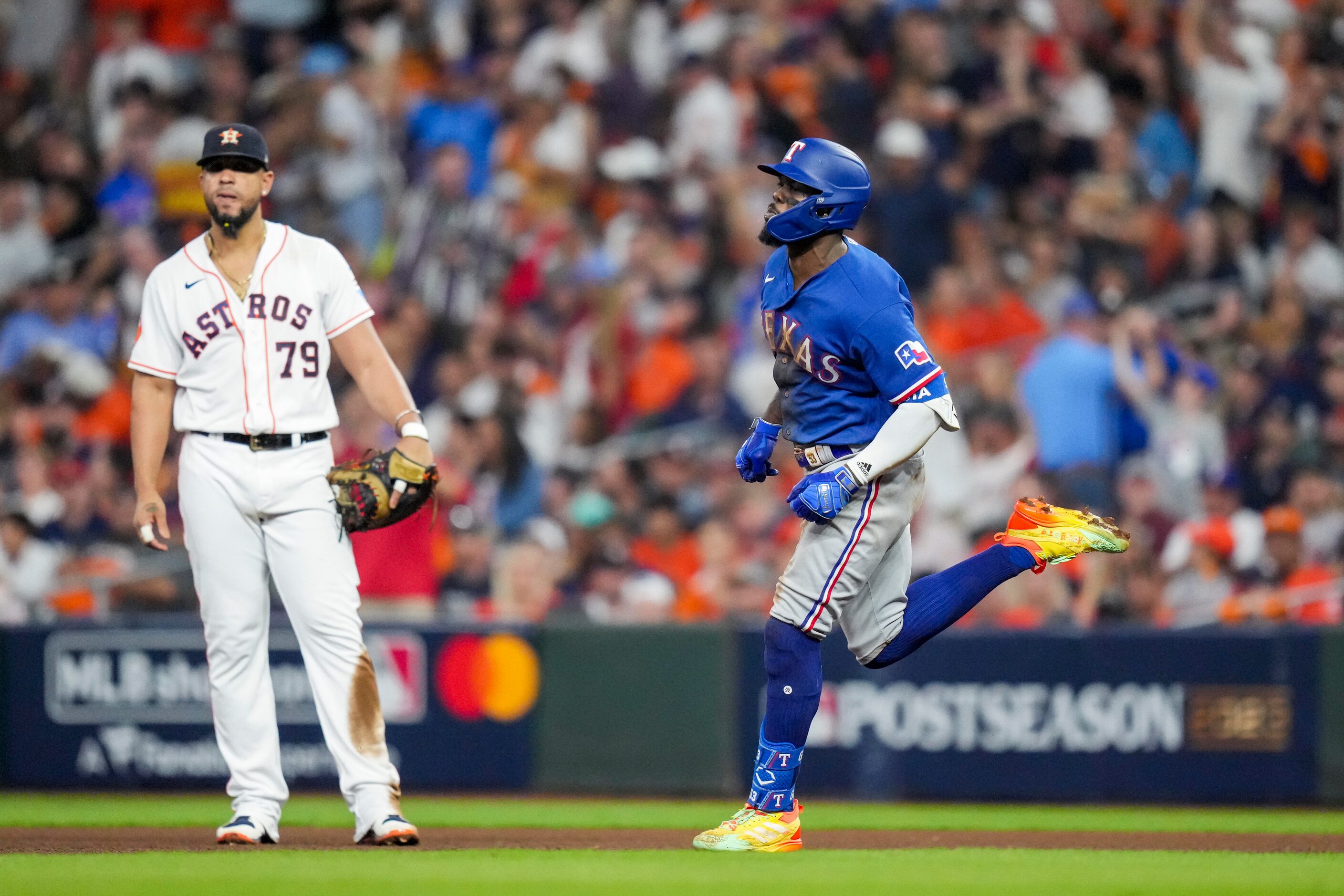 Texas Rangers right fielder Adolis Garcia (53) passes by Houston Astros first baseman Jose...