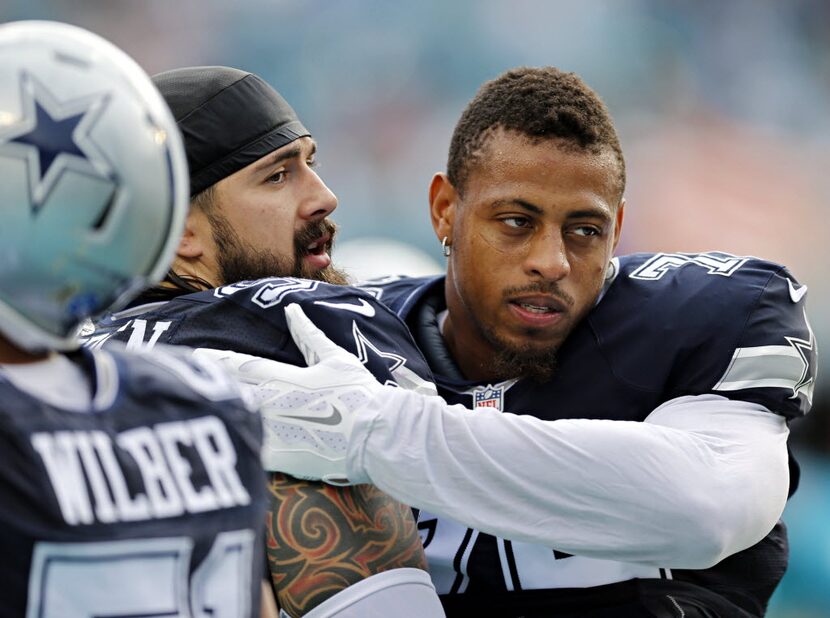 Dallas Cowboys defensive end Greg Hardy (right) hugs defensive tackle Nick Hayden before...