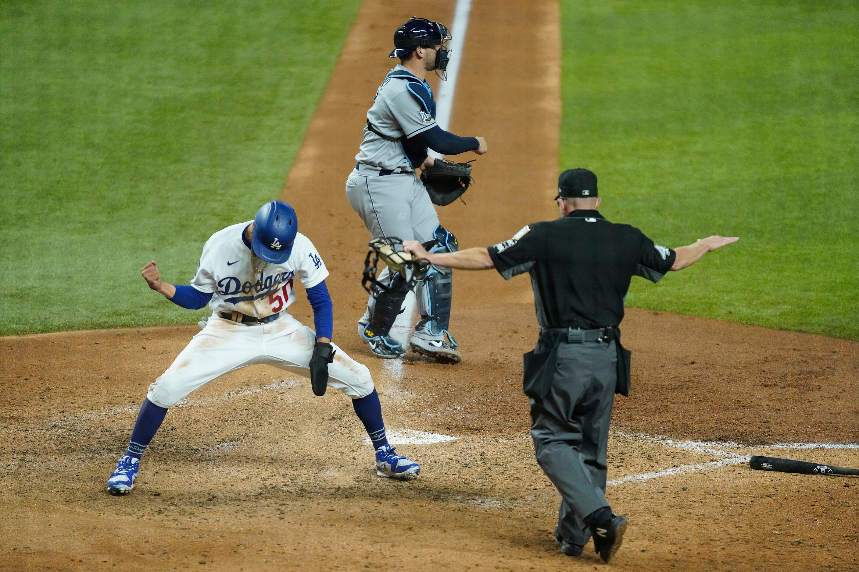 Los Angeles Dodgers right fielder Mookie Betts (50) celebrates after scoring past Tampa Bay...