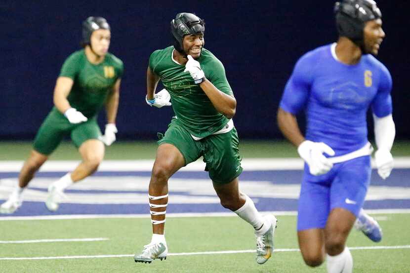 Jahari Rogers (center) of Arlington High School, plays defense during The Opening Finals, a...